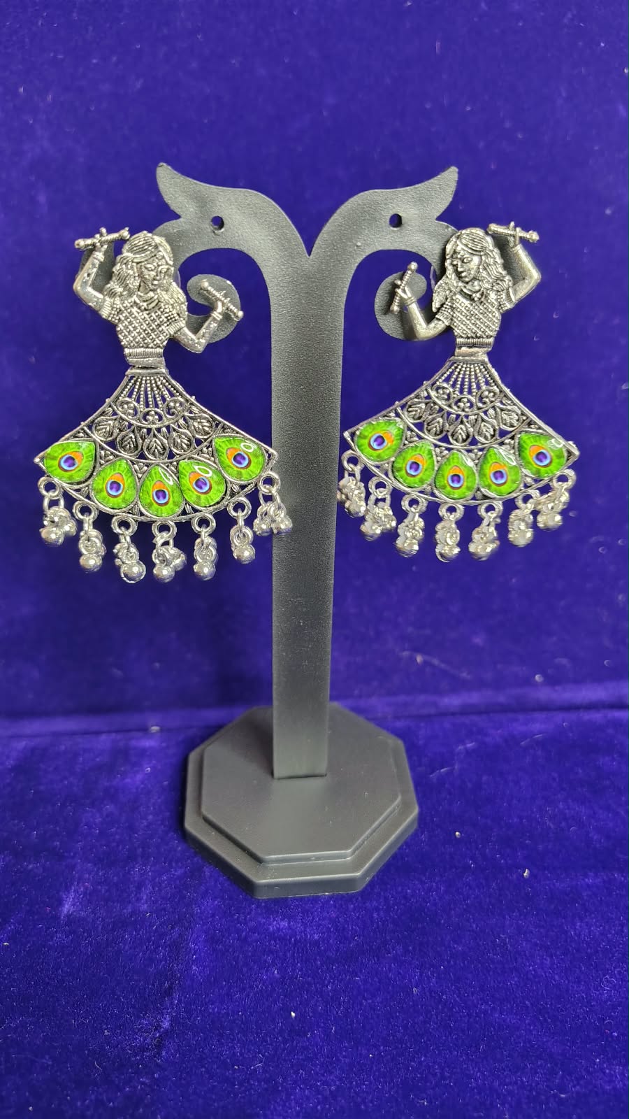 Peacock Flute Player Oxidized Earrings with green mor pankh meenakari on display stand